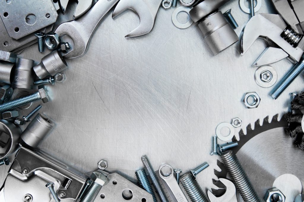 Metal tools and fixing elements on the scratched metal background.